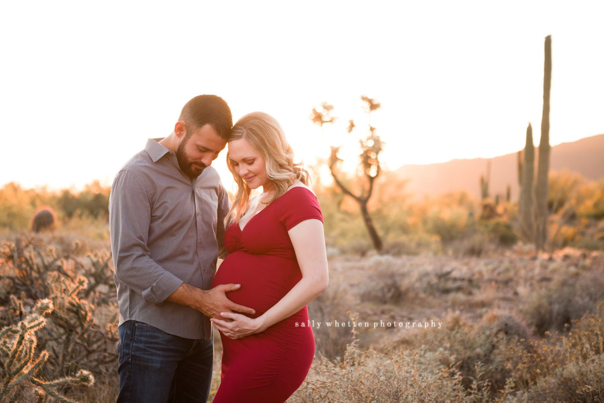 amazing maternity photo in the desert at sunset