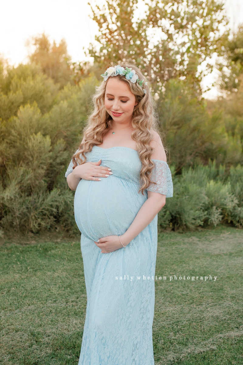 pregnant woman in blue dress with floral crown at one of my top 5 maternity portrait locations