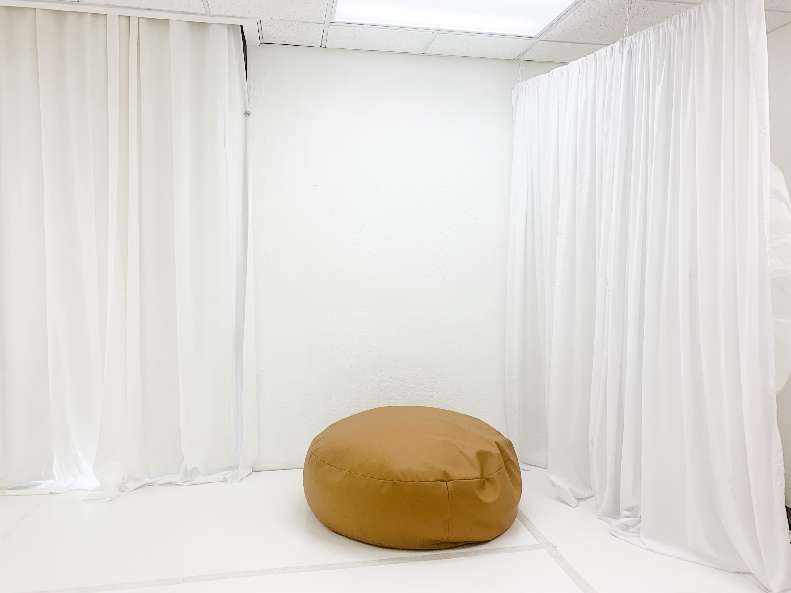 white studio space with newborn bean bag for baby photography sessions