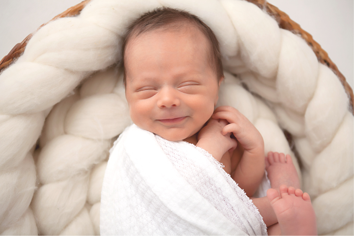 Scottsdale Newborn Photographer newborn boy smiling in his sleep