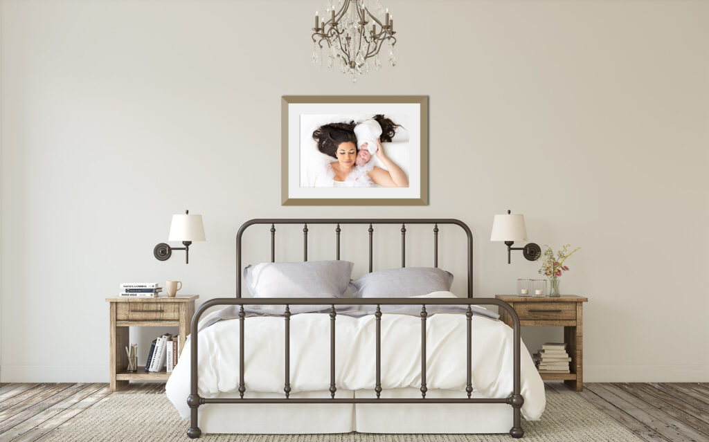 Modern bedroom with large, beautiful portrait of mom and newborn by Sally Whetten Photography hanging above the bed.