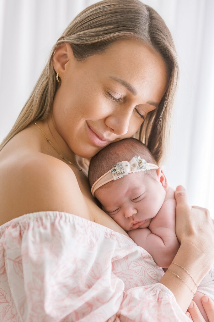 Mom holding newborn baby close during a Scottsdale newborn session