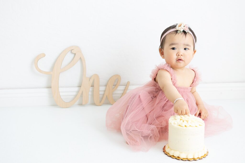 First birthday cake smash with baby girl in light and airy studio