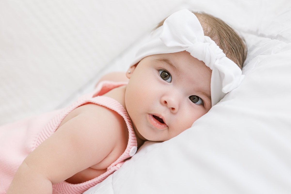 6 month baby girl laying on her tummy in mesa photo studio